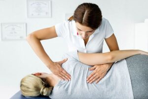 a woman massaging a woman's back